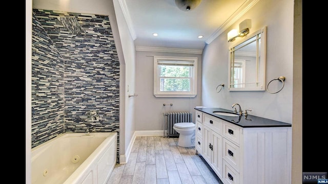 bathroom featuring vanity, radiator, a washtub, ornamental molding, and wood-type flooring