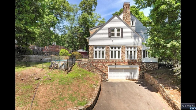 rear view of house featuring a garage