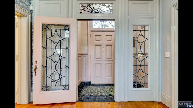 foyer entrance with light hardwood / wood-style floors