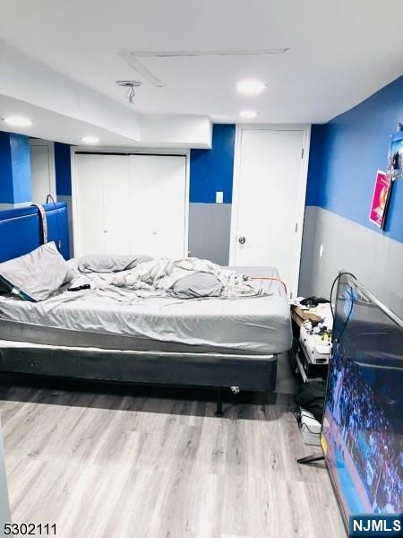 bedroom with wood-type flooring