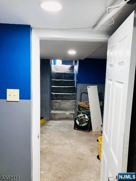 staircase with concrete flooring