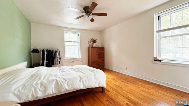 bedroom with ceiling fan and light hardwood / wood-style flooring