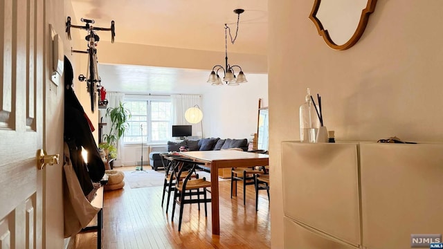 dining space with a chandelier and hardwood / wood-style flooring