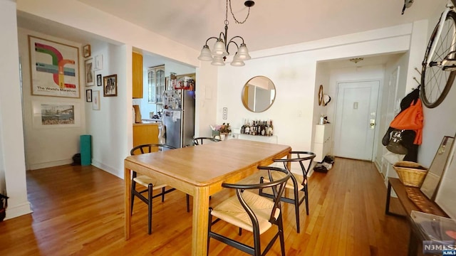 dining area featuring a chandelier and wood-type flooring