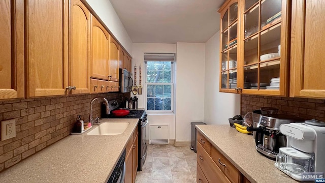 kitchen featuring decorative backsplash, sink, and stainless steel appliances