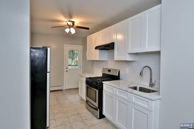 kitchen featuring sink, black refrigerator, white cabinets, and stainless steel range with gas stovetop