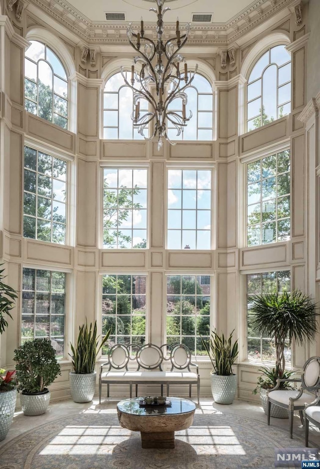 sunroom featuring a notable chandelier