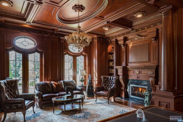 living area featuring coffered ceiling, crown molding, and french doors