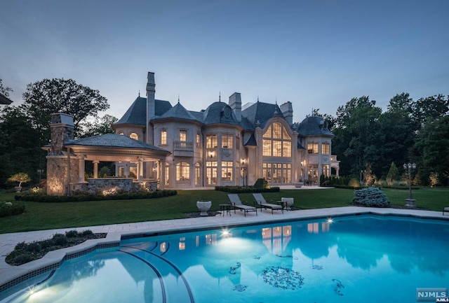 pool at dusk with a yard