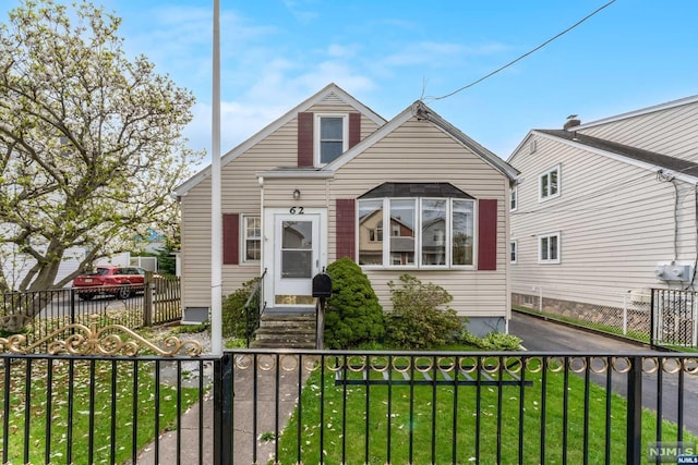 bungalow-style home featuring a front lawn