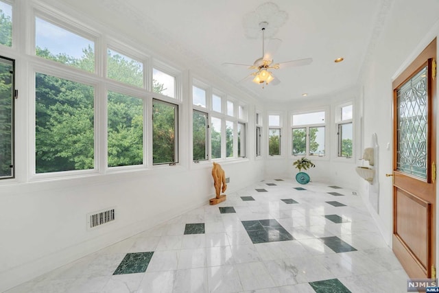 sunroom featuring ceiling fan