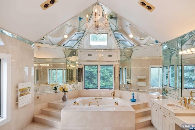 bathroom featuring vanity and tiled bath