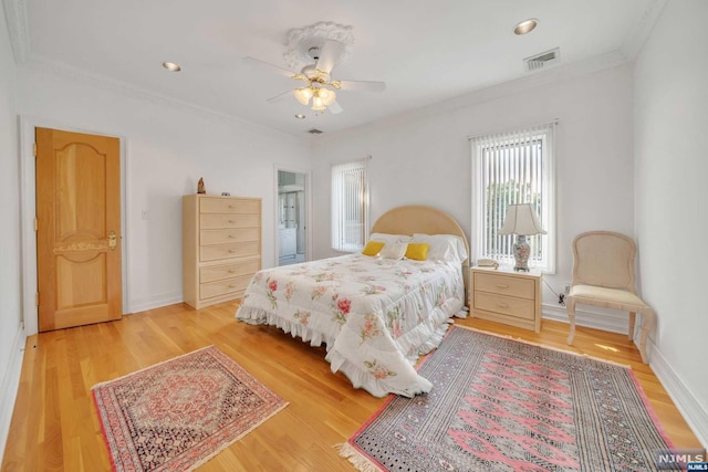 bedroom with light hardwood / wood-style flooring, ceiling fan, and ornamental molding