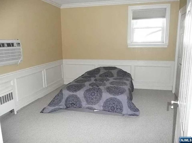 bedroom with carpet, an AC wall unit, and ornamental molding