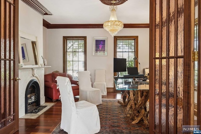 sitting room with a wealth of natural light, crown molding, and dark hardwood / wood-style floors