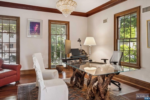 living area with a chandelier, dark wood-type flooring, and ornamental molding