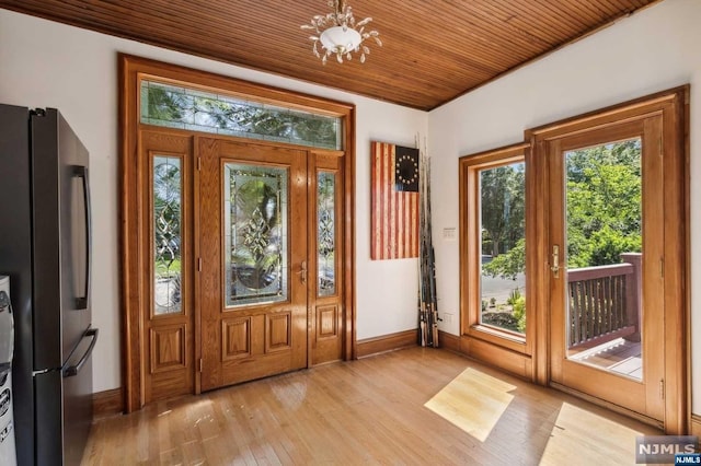 entryway featuring wooden ceiling, light wood-type flooring, and a chandelier