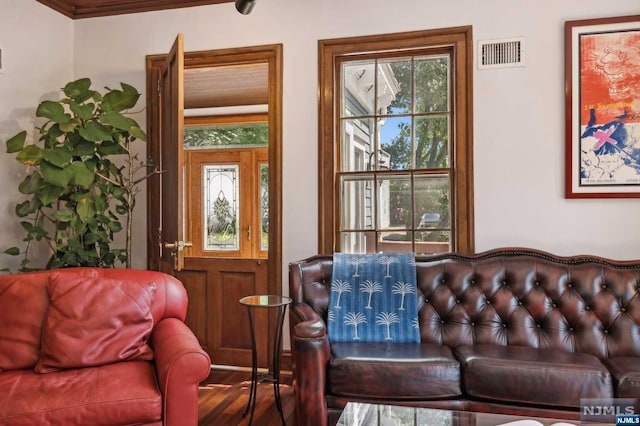 living room featuring wood-type flooring and ornamental molding