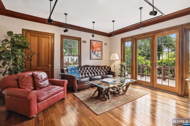 living room with hardwood / wood-style floors, french doors, and ornamental molding