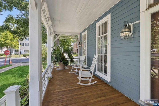 wooden terrace featuring a porch