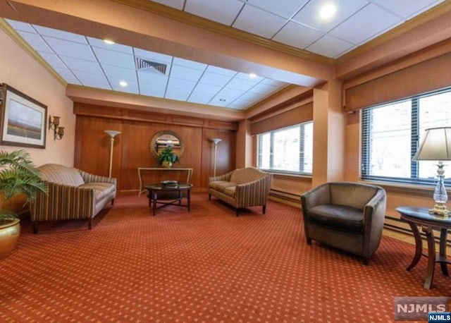 living area with crown molding and carpet floors