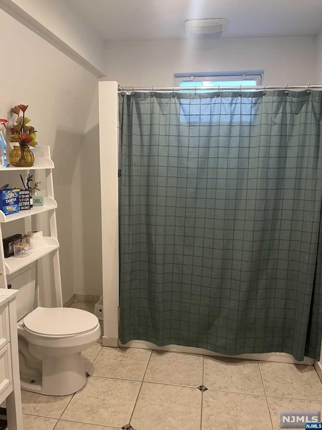 bathroom with toilet, vanity, tile patterned floors, and a shower with shower curtain