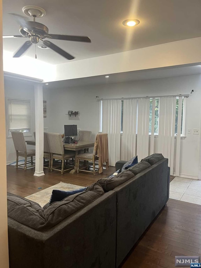 living room featuring hardwood / wood-style floors and ceiling fan