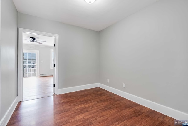 unfurnished room featuring hardwood / wood-style flooring, baseboard heating, and ceiling fan