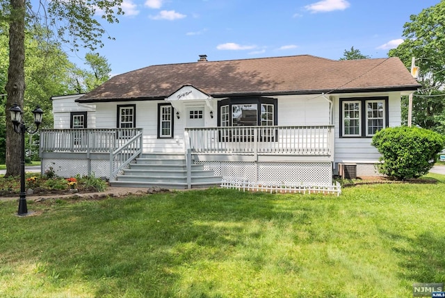 single story home featuring a porch, a front yard, and central AC