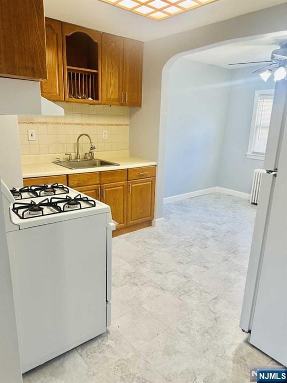 821 Roosevelt Ave, Secaucus, NJ 07094 - kitchen featuring tasteful backsplash, sink, white appliances, and ceiling fan