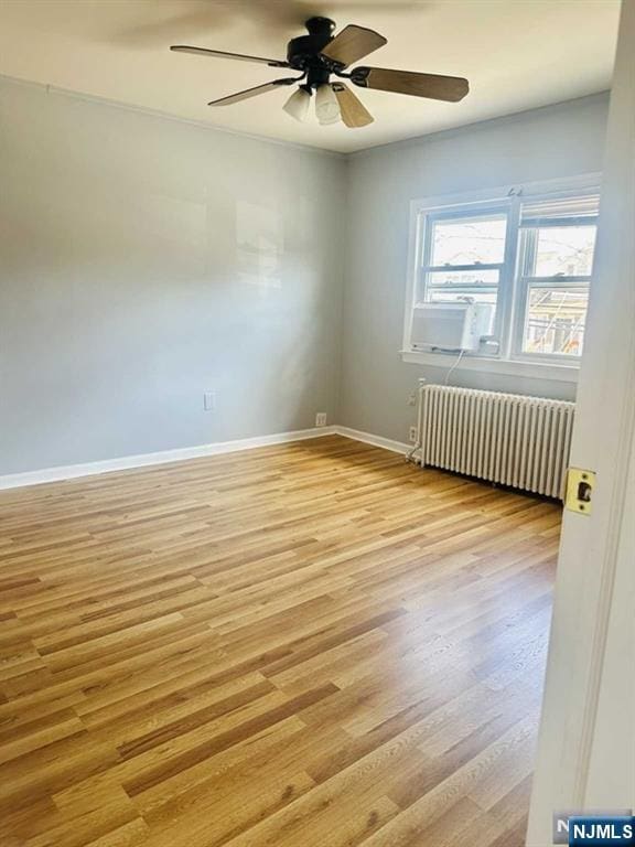 821 Roosevelt Ave, Secaucus, NJ 07094 - spare room featuring ceiling fan, radiator, and light wood-type flooring