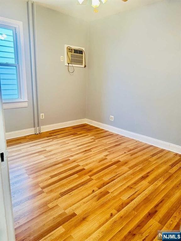 821 Roosevelt Ave, Secaucus, NJ 07094 - unfurnished room featuring ceiling fan, a wall mounted AC, and light hardwood / wood-style floors