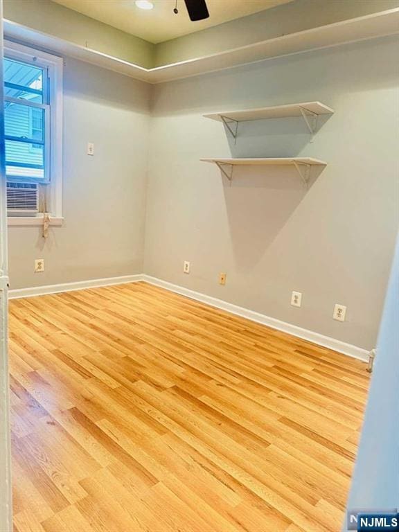 821 Roosevelt Ave, Secaucus, NJ 07094 - empty room with cooling unit, ceiling fan, and light wood-type flooring