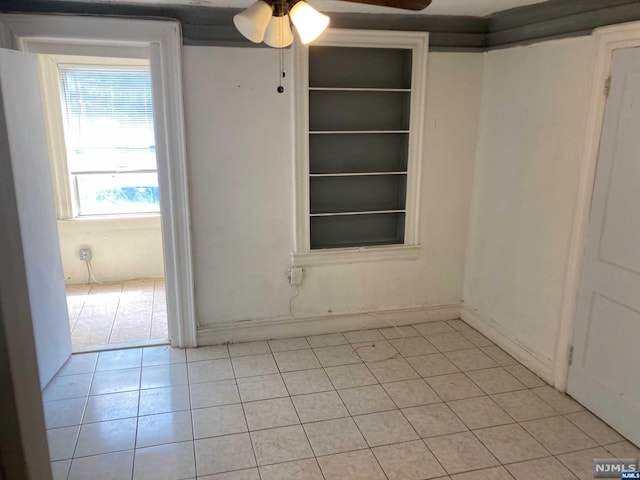 tiled empty room with ceiling fan