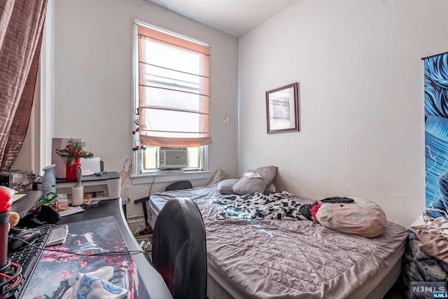 bedroom featuring cooling unit and multiple windows