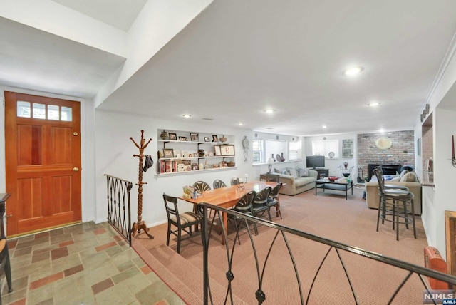 dining room featuring a brick fireplace