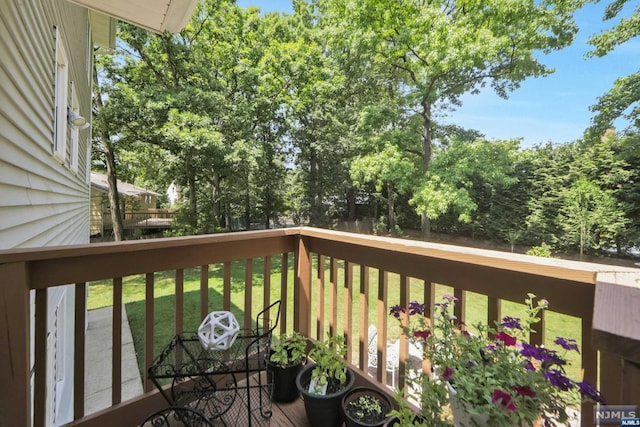 wooden deck with a lawn