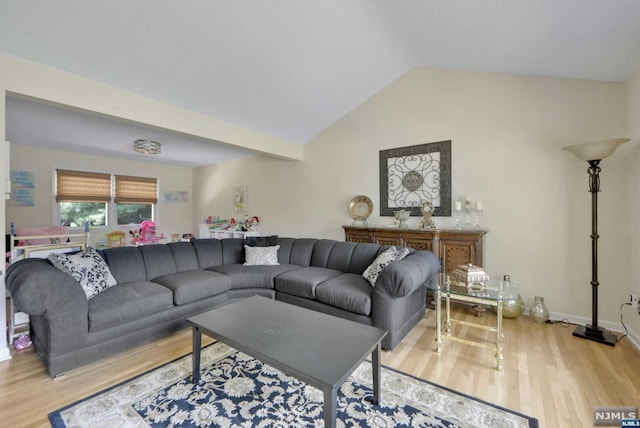 living room featuring light hardwood / wood-style floors and lofted ceiling