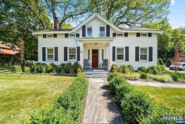 colonial home with a front lawn