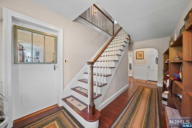 staircase with hardwood / wood-style floors