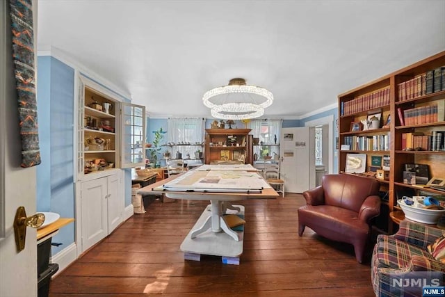 recreation room with a chandelier, dark hardwood / wood-style flooring, and ornamental molding