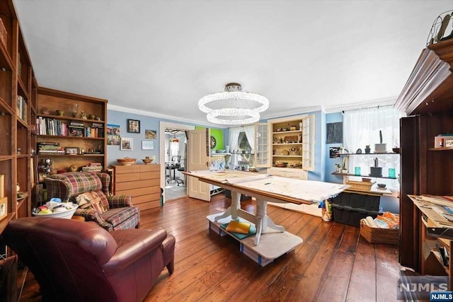 interior space with dark hardwood / wood-style flooring, crown molding, a wealth of natural light, and an inviting chandelier