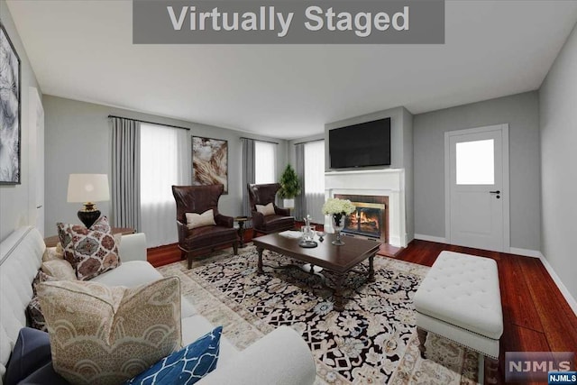 living room featuring a wealth of natural light and hardwood / wood-style flooring