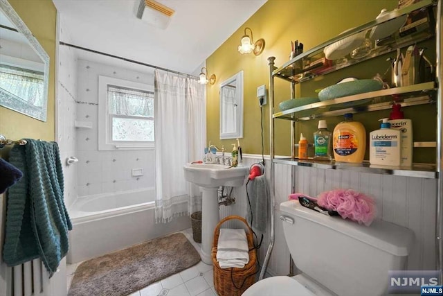 bathroom featuring shower / bath combo and toilet