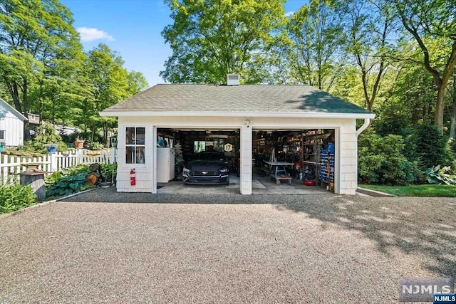 view of vehicle parking with a garage