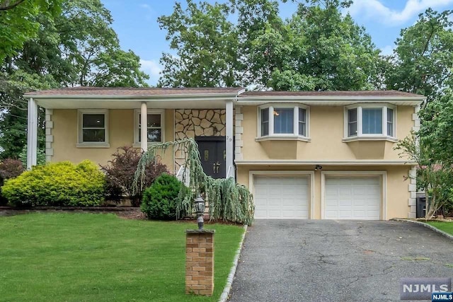 view of front of house with a garage and a front yard