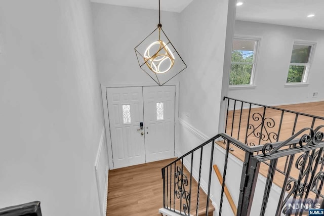 foyer entrance featuring a chandelier and light hardwood / wood-style flooring