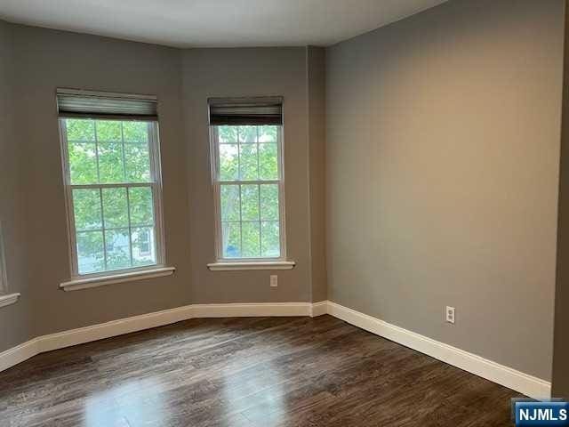 spare room featuring dark hardwood / wood-style flooring