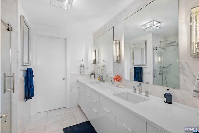 bathroom with tile patterned flooring, vanity, and an enclosed shower