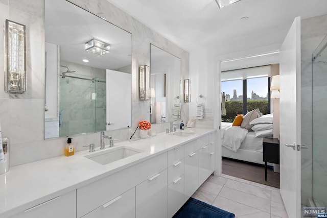 bathroom with vanity and a shower with door